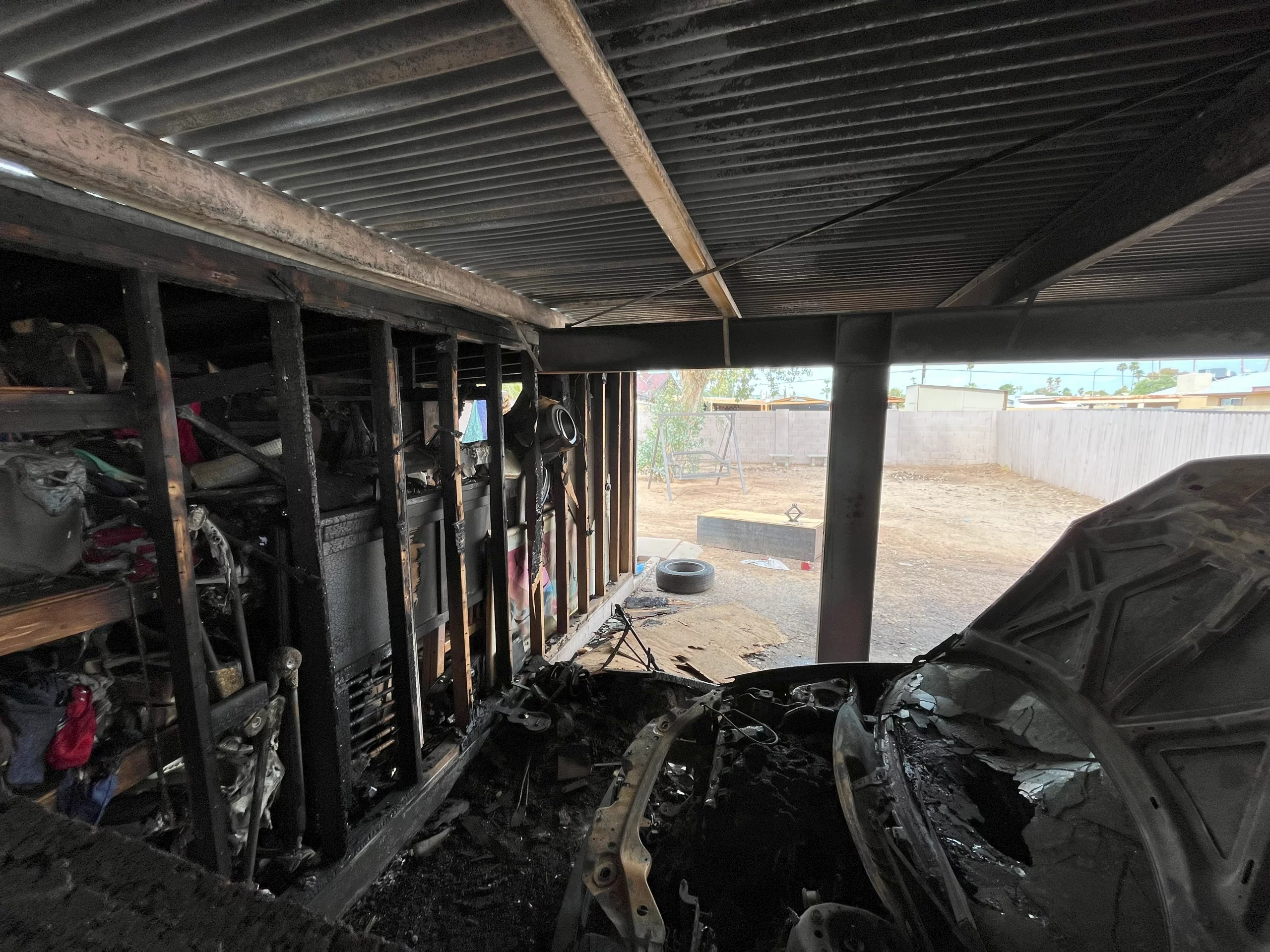 Burnt Exterior Wall. Burnt Studs, Black Roof and Burnt Personal Belongings Due to Fire Damage