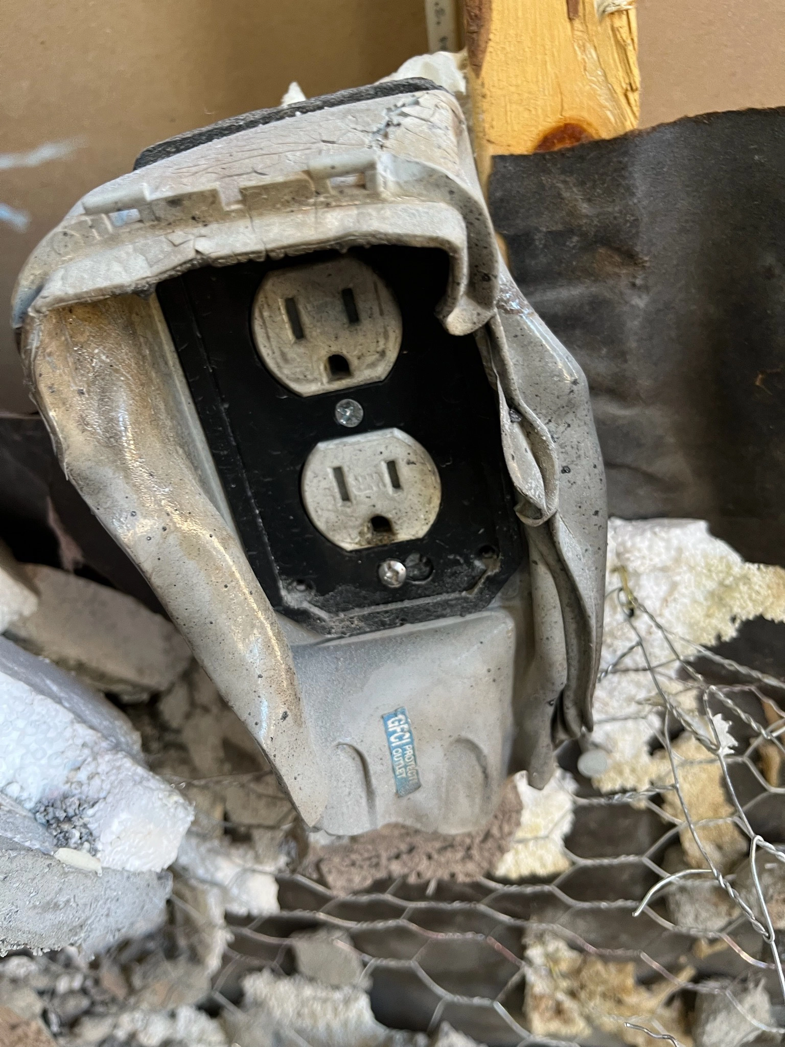 Melted Electrical Outlet and Burnt Stucco From Fire Damage