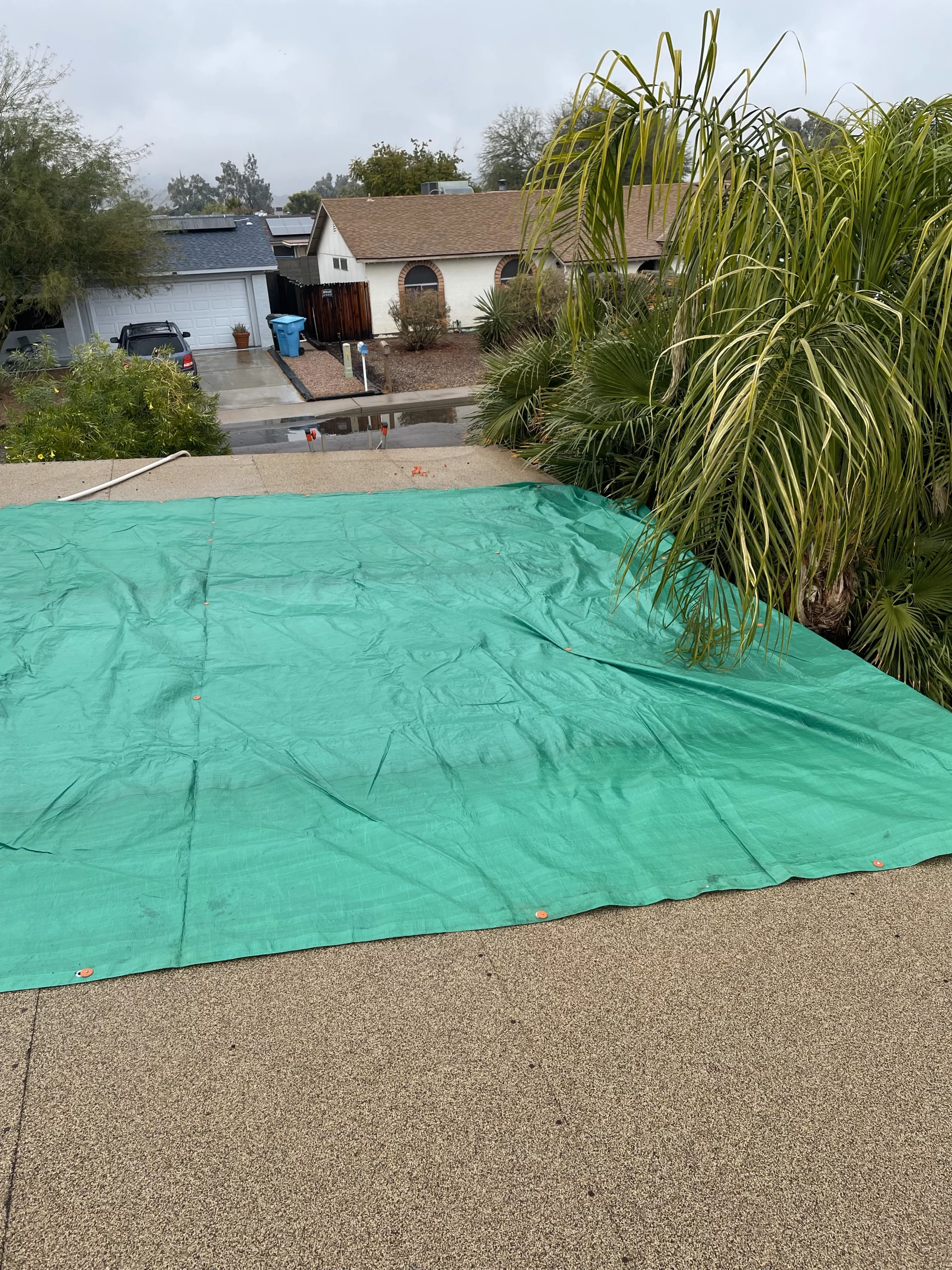 Storm and Wind Damage Roof and Is Tarped to Prevent Additional Water Leak Inside